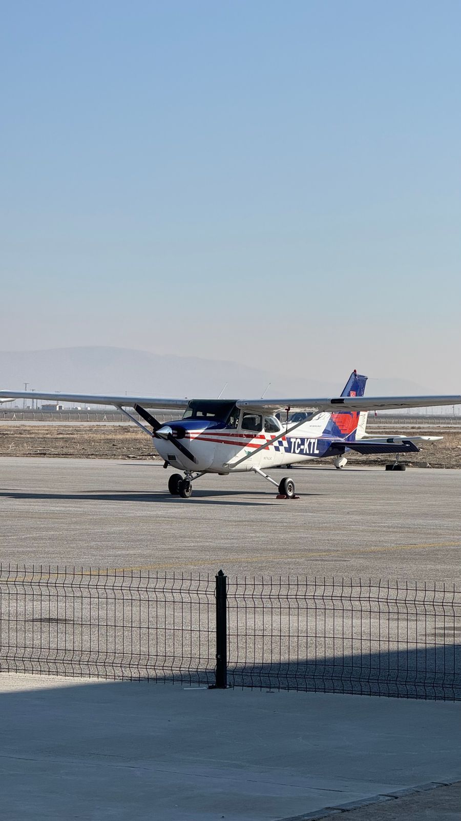 A training aircraft on the apron on a clear day