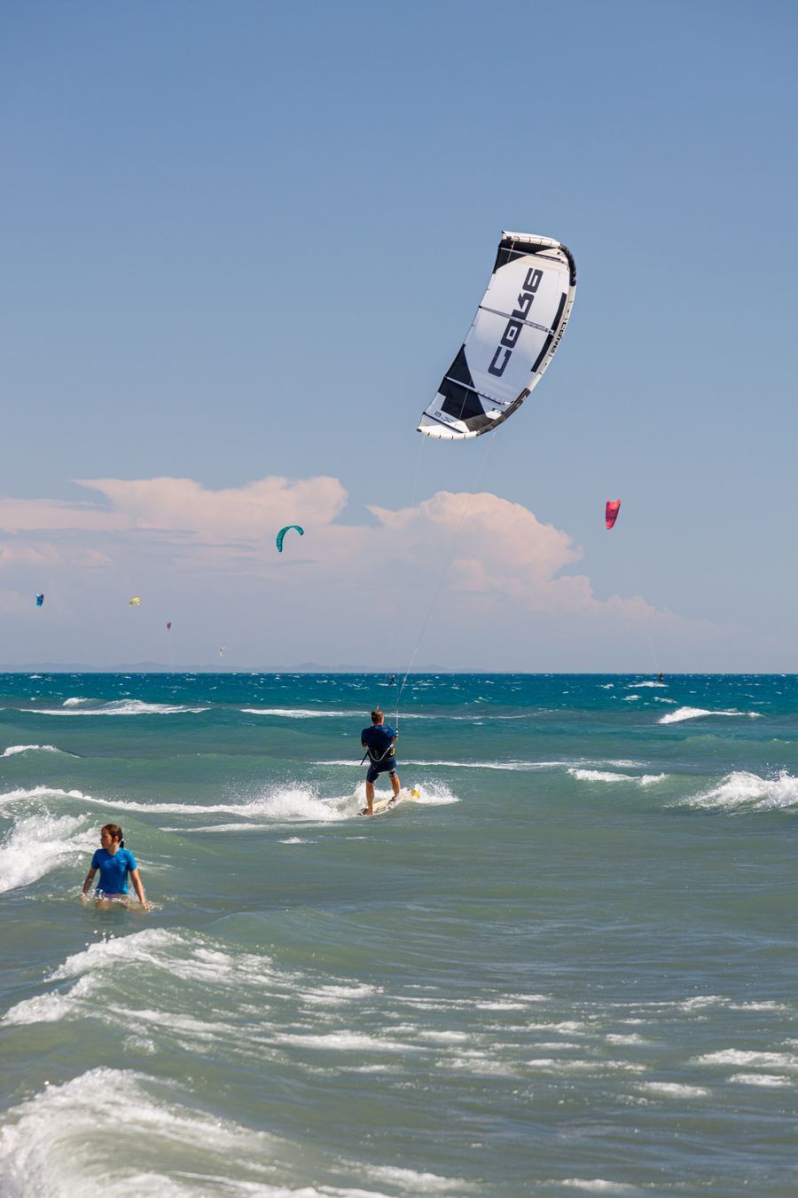 Kites flying over a busy beach