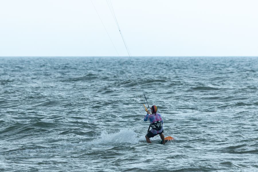 A kitesurfer riding close to shore