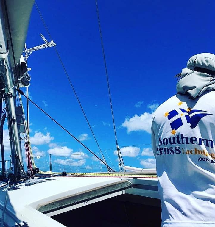 A sailor in Southern Cross Yachting kit aboard a sailing yacht